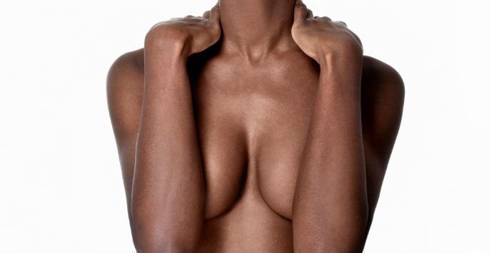 Woman covering breasts with arms