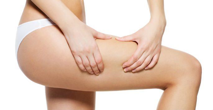 Woman holding thigh considering thighplasty