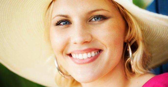 Woman in a hat smiling at camera