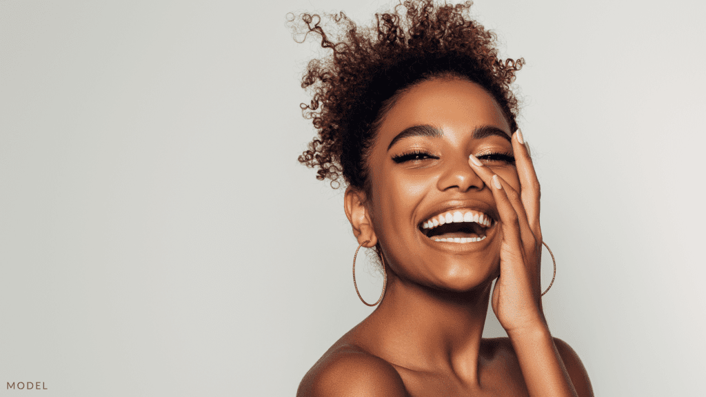 A woman with glowing skin and earrings (model).