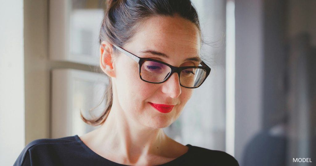 Woman using computer to consider treatments to address signs of aging